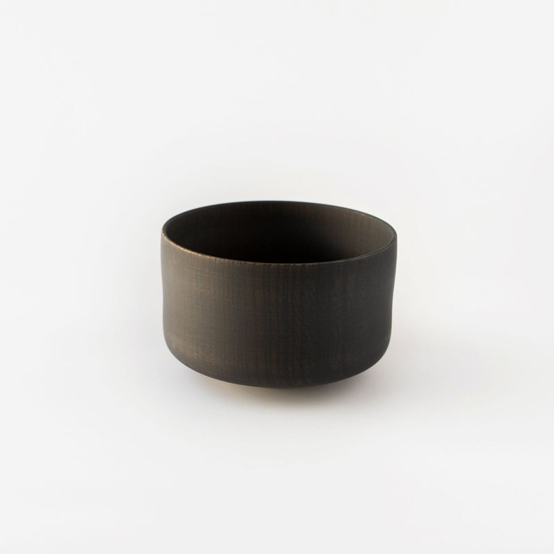 A Nishimoto Keyaki Wood Matcha Bowl crafted from sustainable wood, resting on a serene white background.